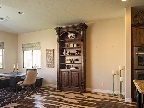 closed ornate single bookcase hidden door.