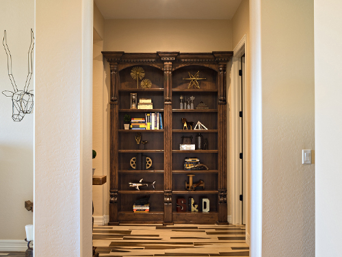 Large Bookcase in wall filled with objects and books.