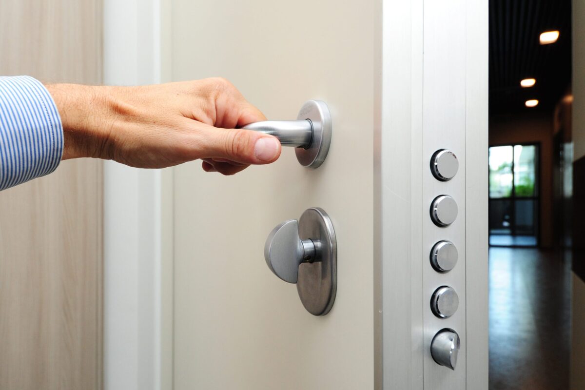 Person opening a door with vault locks.