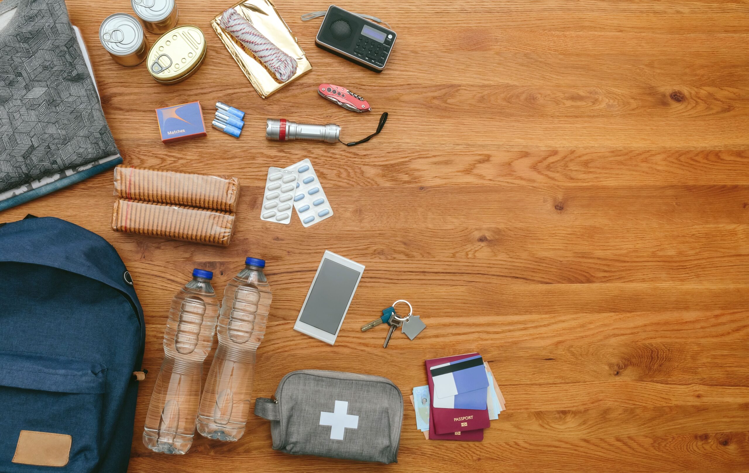 Emergency kit backpack with water, a first aid kit, bandaids and rope.