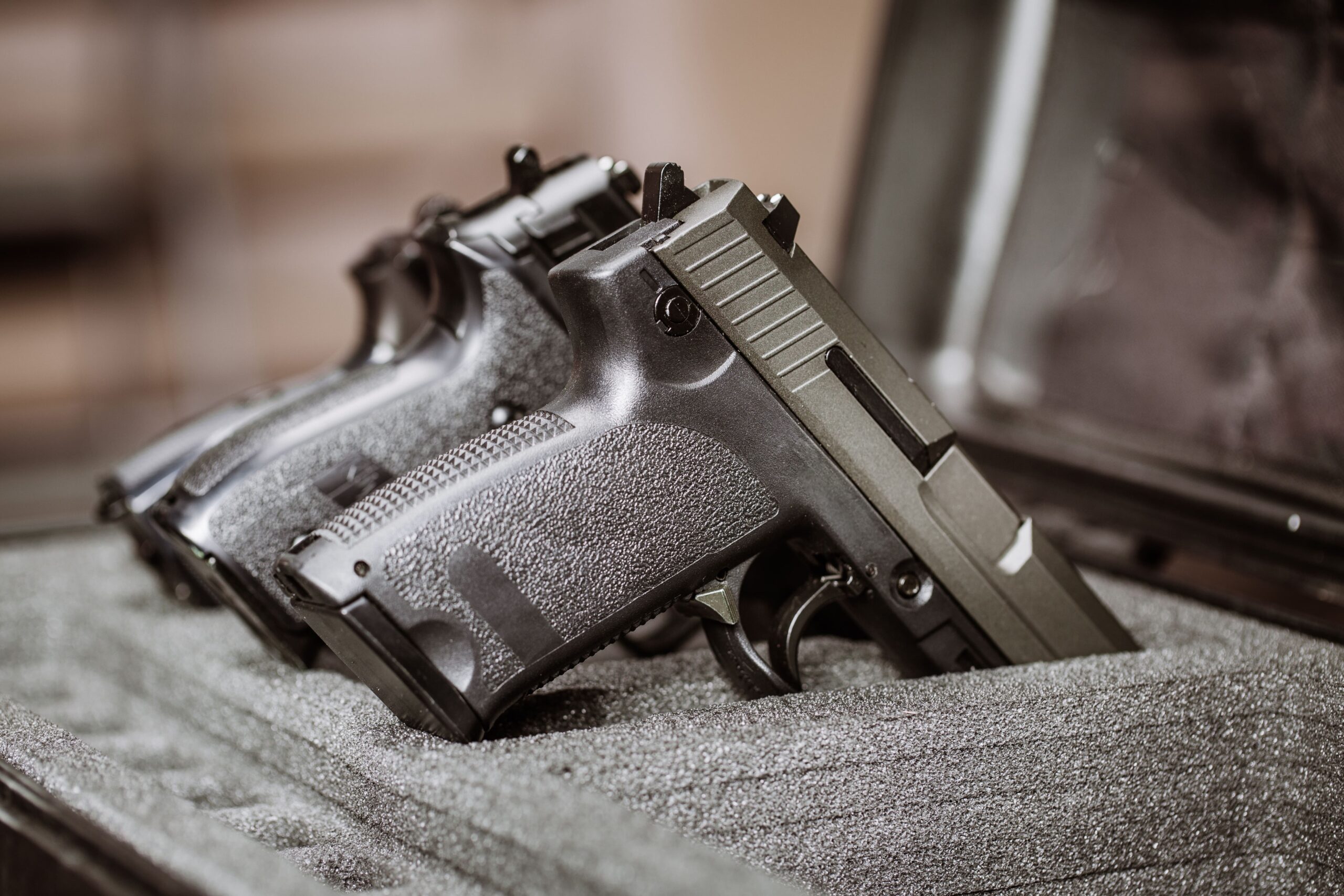 Guns resting in a safety box.