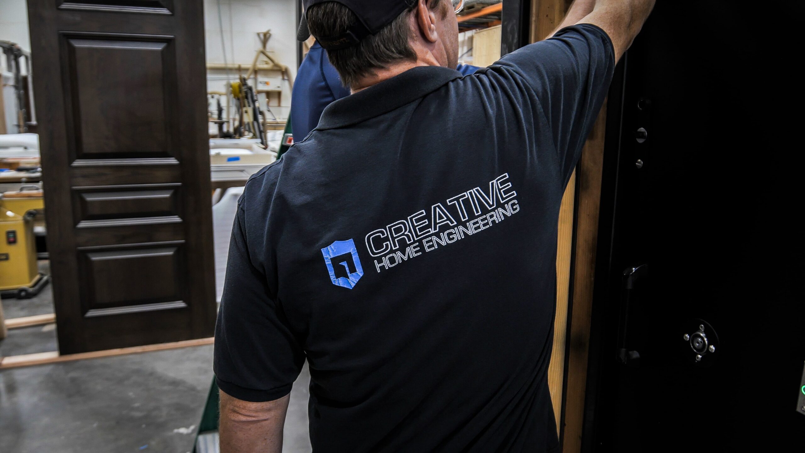 Manufacturing engineer on floor of shop building a hidden door.