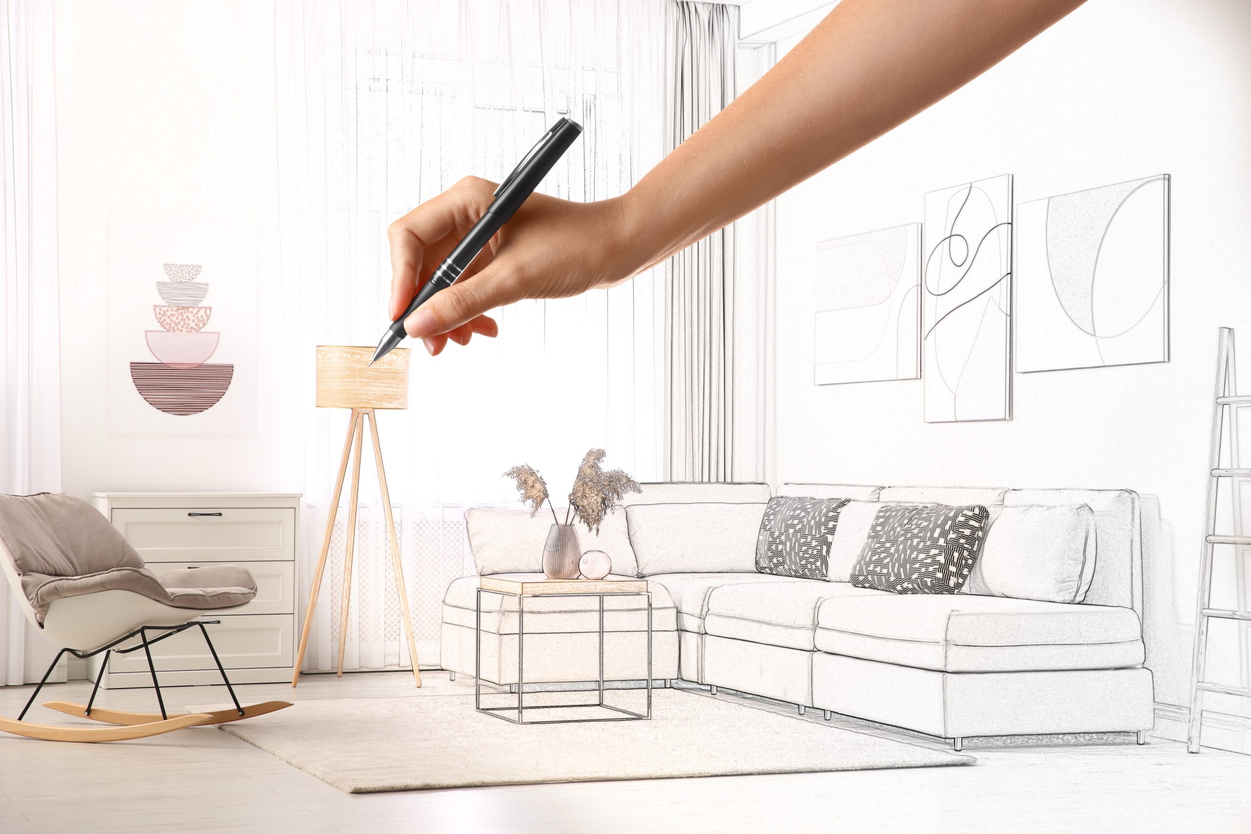 Woman drawing a living room floor plan sketch.