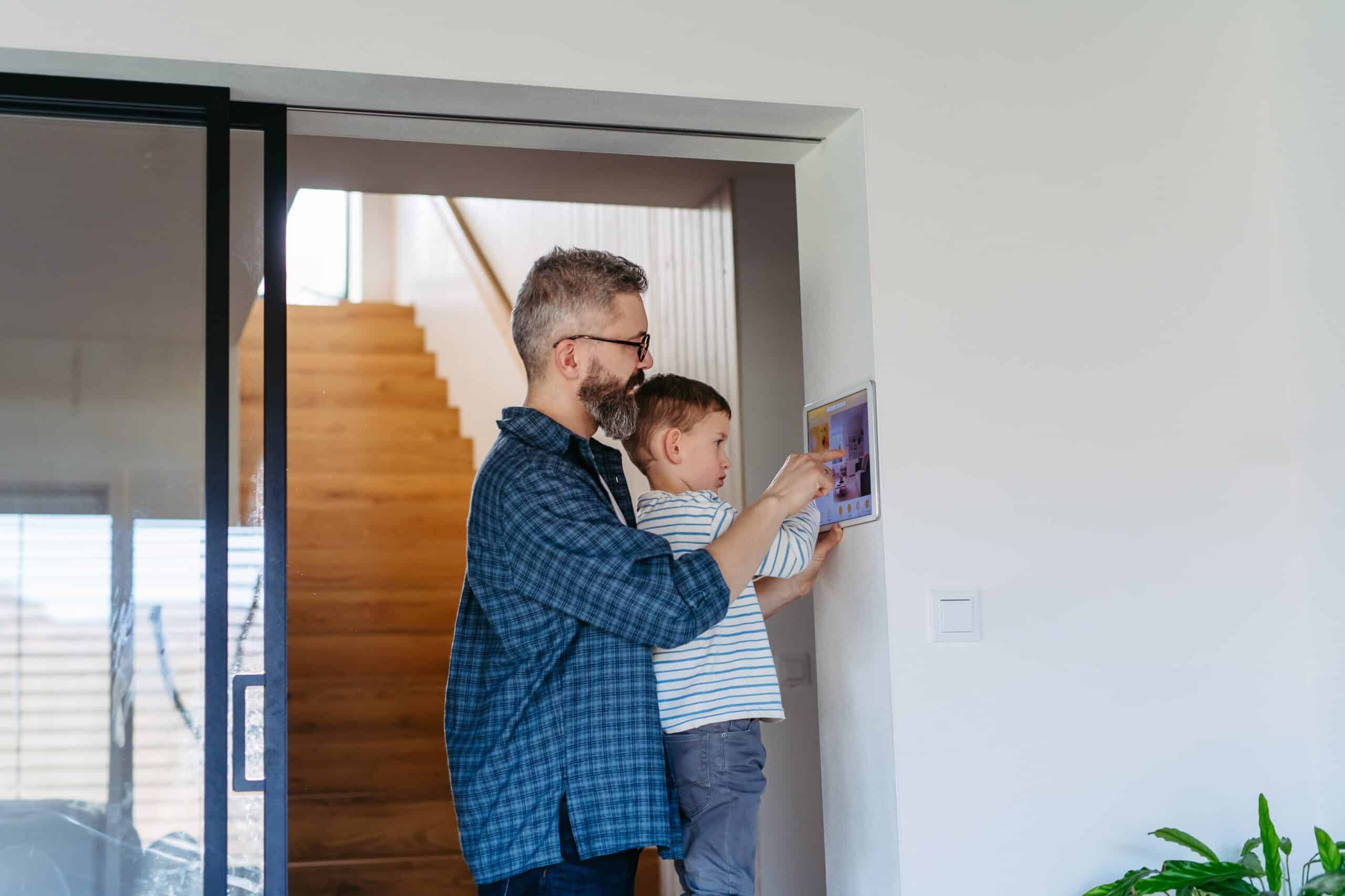 man with his son setting home security system